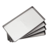 Stack of four stainless steel HarvestRight freeze dryer trays, angled view.