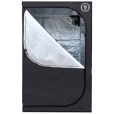 Black grow tent with partially open zippered door, revealing a highly reflective silver interior for optimal plant growth.