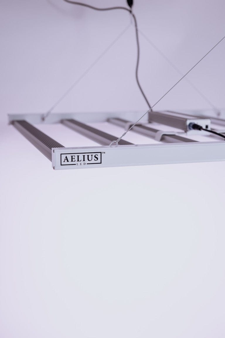 Aelius LED grow light with four bars and a logo.
