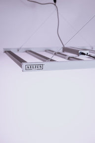 Aelius LED grow light with four bars and a logo.