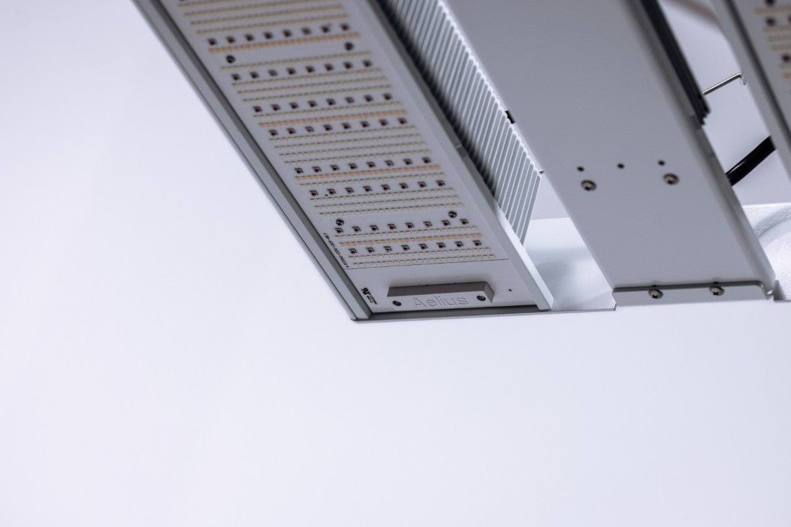 Close-up of a full-spectrum LED grow light with "Aelius" logo visible.