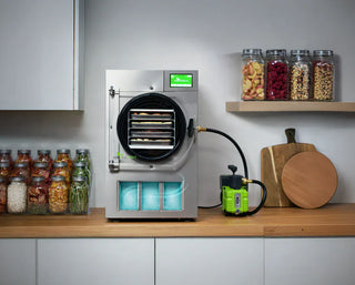 Harvest Right freeze dryer with pump and jars of preserved food on shelf and counter.