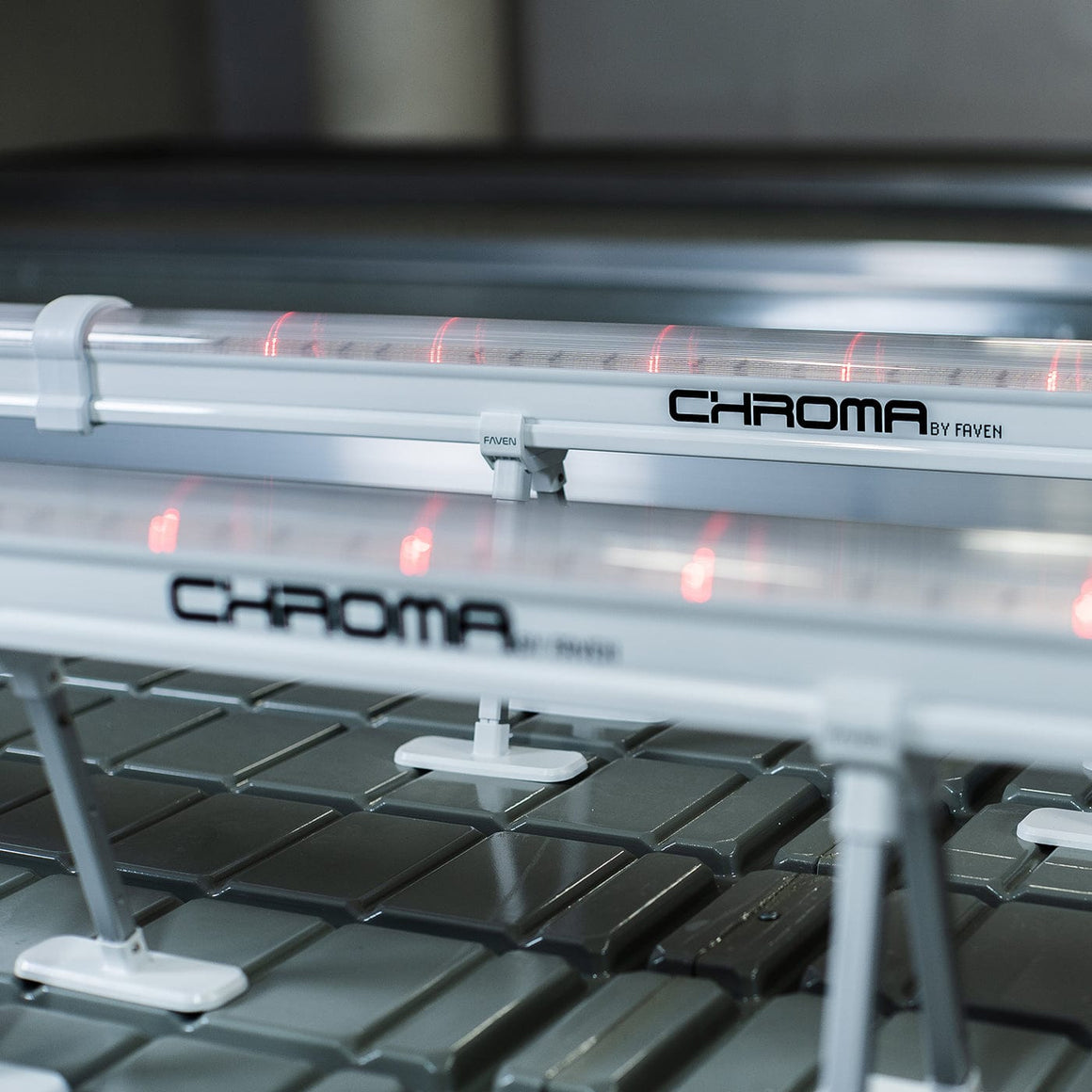 CHROMA by FAVEN lighting system with red LED lights over a textured surface.