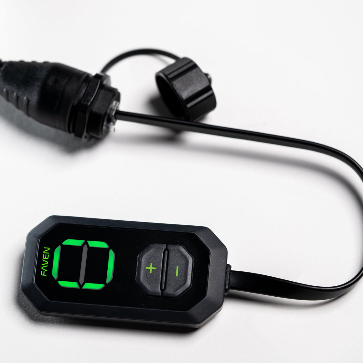 Black Faven lighting controller with green LED display showing "00", plus/minus buttons, and attached cable with connector.