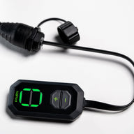 A black Faven lighting controller with a digital display and +/- buttons.