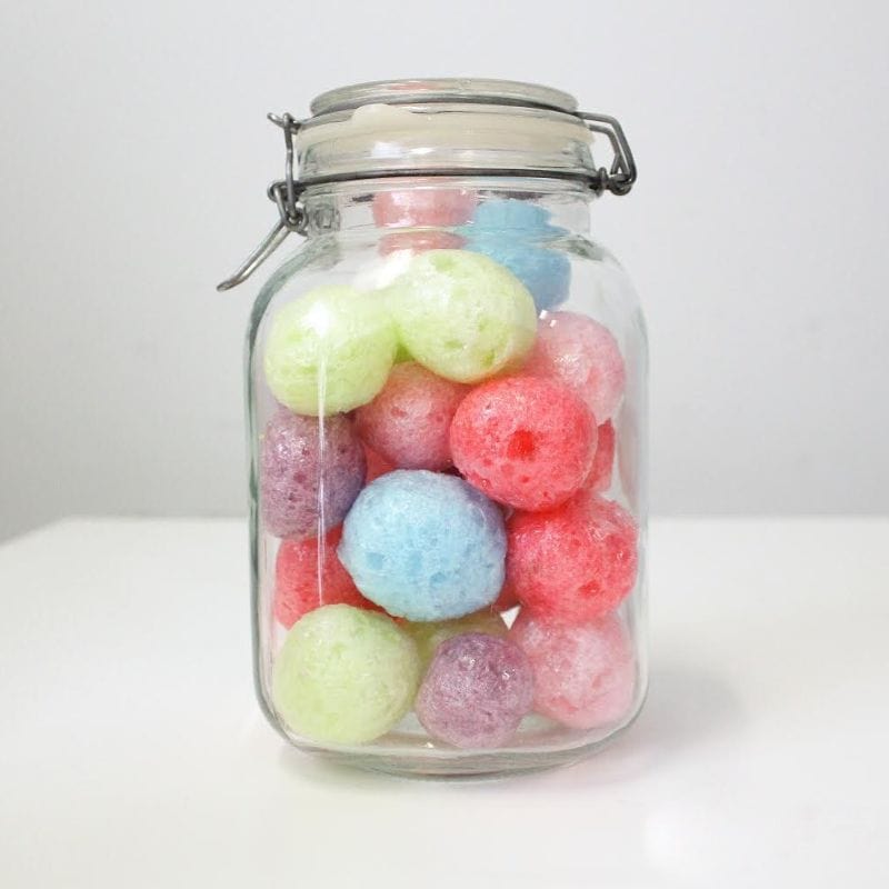 Clear glass jar filled with colorful, textured freeze-dried hard candies: green, blue, pink, red, purple.