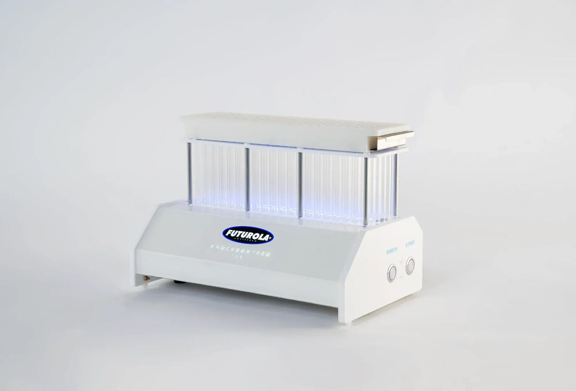 Futurola Knockbox Pro cone filling machine with clear tubes and blue LED lighting.
