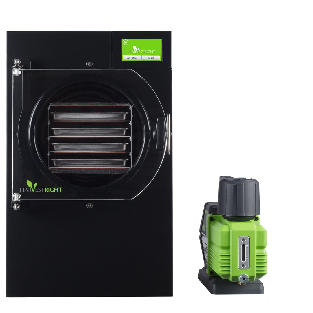 Harvest Right black small home freeze dryer with internal trays, display screen, and a green vacuum pump.