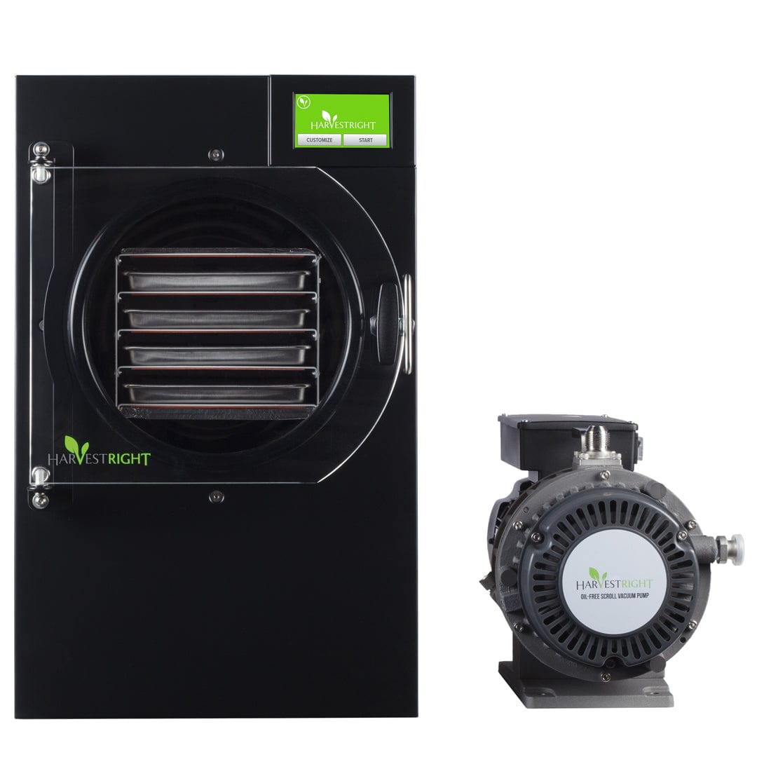 Harvest Right black home freeze dryer with internal trays and an accompanying oil-free scroll vacuum pump.