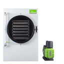 White Harvest Right large home freeze dryer with interior trays, next to a green Harvest Right vacuum pump.