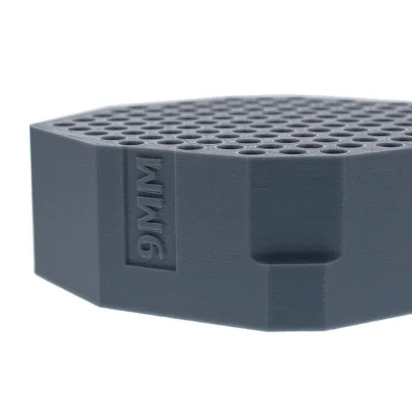 Gray 9MM cartridge holder with honeycomb-like top surface.