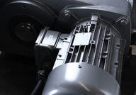 Close-up of a heavy-duty industrial motor with fins and a junction box.