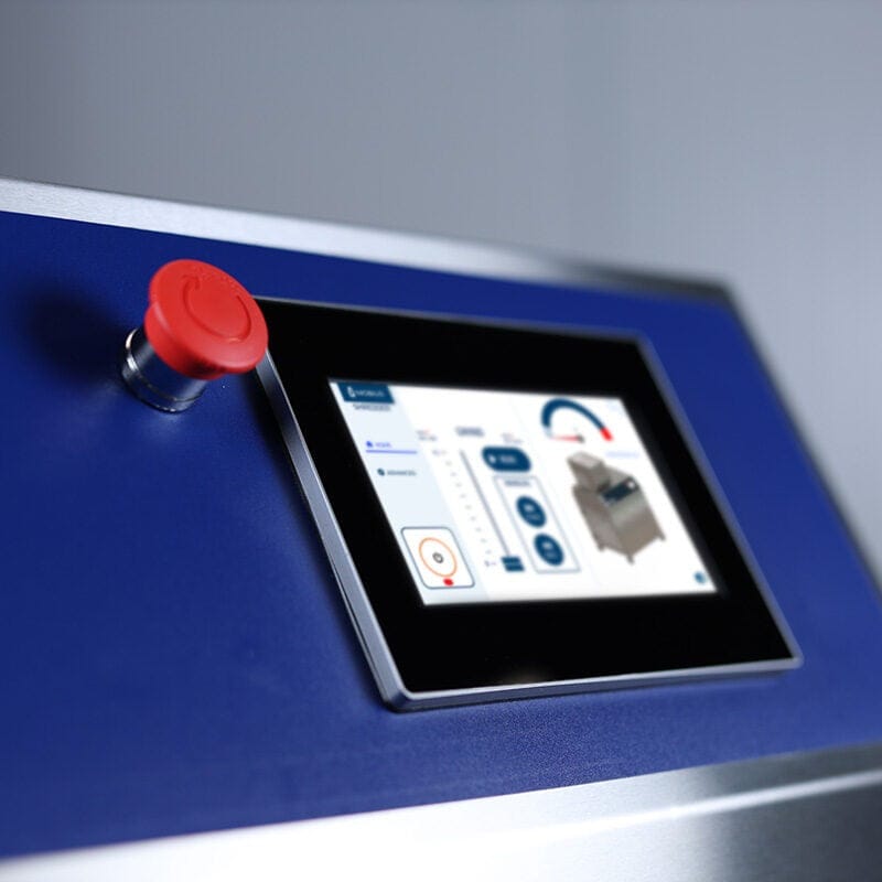 Industrial waste shredder control panel with touchscreen and red emergency stop button.