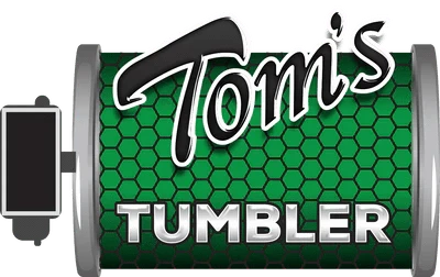 Tom's Tumbler logo: Black script 'Tom's' & shiny silver 'TUMBLER' on green honeycomb pattern, inside a machine drum.