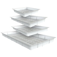 White plastic flood trays stacked, with grid inserts, on white background.