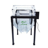 Tom's Tumbler 2600 dry bud trimming machine on a black stand with clear plastic components and green logo.